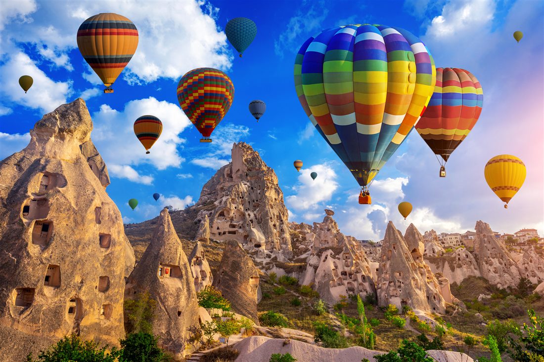 Hot-air balloons over the carved valleys of Cappadocia